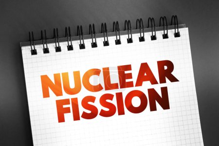 Photo for Nuclear fission - reaction in which the nucleus of an atom splits into two or more smaller nuclei, text concept on notepad - Royalty Free Image