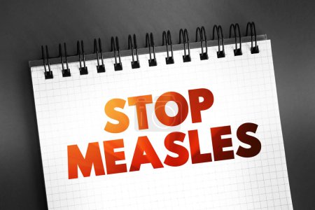 Photo for Stop Measles - get the measles, mumps, and rubella (MMR) vaccine, text on notepad, concept background - Royalty Free Image