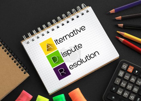 ADR - Alternative Dispute Resolution acronym on notepad, business concept background