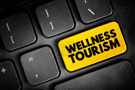 Foto de Wellness tourism - travel for the purpose of promoting health and well-being through physical, psychological, or spiritual activities, text concept button on keyboard - Imagen libre de derechos