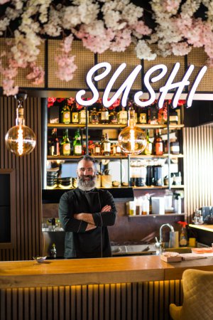 Photo for Portrait of sushi chef at sushi restaurant. - Royalty Free Image