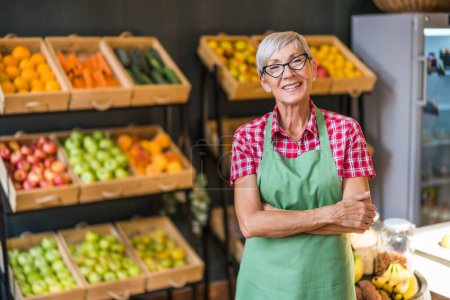 Photo for Mature woman works in fruits and vegetables shop. Portrait of small business supermarket owner. - Royalty Free Image