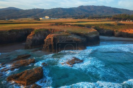 Photo for Aerial view of the Cathedrals beach (Playa de las Catedrales) or Praia de Augas Santas at sunrise, amazing landscape with rocks and Atlantic Ocean, Ribadeo, Galicia, Spain. Outdoor travel background - Royalty Free Image