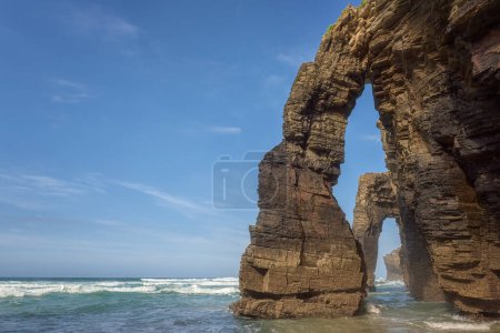 Cathedrals beach (Playa de las Catedrales) or Praia de Augas Santas at low tide, bizarre natural rocks and caves, tourist attraction in Ribadeo, Galicia, Spain. Outdoor travel background