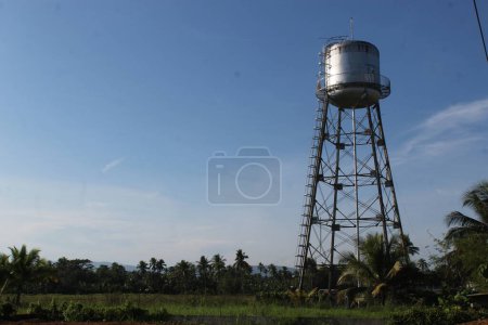 Photo for Rice Field Stunning a Big Water tank Supply Consumer over the Town - Royalty Free Image