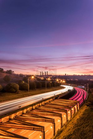 Photo for Winter sunrise and trails of lights on the M-40 highway, Madrid. - Royalty Free Image