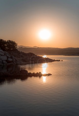 Photo for Summer sunrise, dawn over the waters of the Atazar reservoir, El Berrueco, Madrid - Royalty Free Image