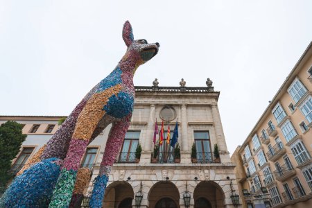 Foto de Gandia, Spain - 15 March 2022: 'Ninot' figurine dog , large paper mache statue, for the traditional celebration 'Fallas' on the main square - Imagen libre de derechos
