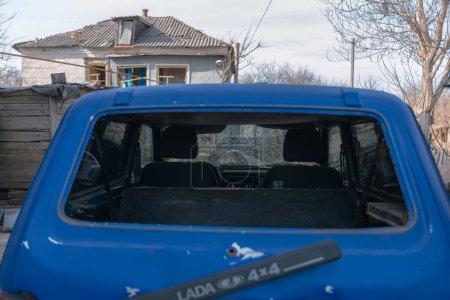 A damaged car after a missile attack on a private residential area. War in Ukraine, the city of Dnipro. Damn car. War concept. Broken windows.