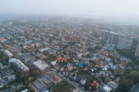 Aerial view of Dnipto city, Ukraine in fog. Cityscape. Panoramic view. Foggy metropolis. Ghost town. Atmospheric shot.