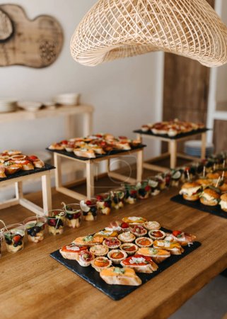 Assorted canapes on a catering table at home.