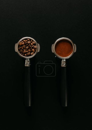 Photo for Two espresso portafilters on a black surface, one filled with coffee beans and the other with ground coffee. - Royalty Free Image