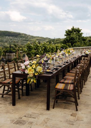 Photo for Outdoor wedding dining setup with rustic charm at a winery. - Royalty Free Image