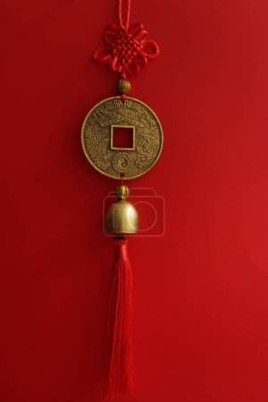 Photo for Red Knot and Brass coin with Chinese Script for Good luck , on Red Background - Royalty Free Image