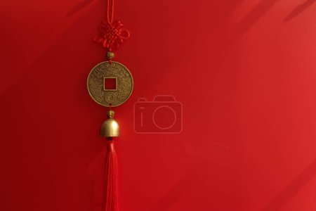 Photo for Red Knot and Brass coin with Chinese Script for Good luck , on Red Background - Royalty Free Image