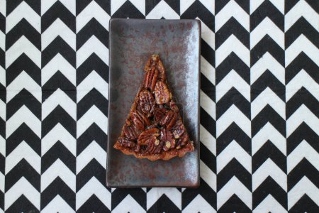 Photo for Close up Pecan pie on Rustic Plate and Black background - Royalty Free Image