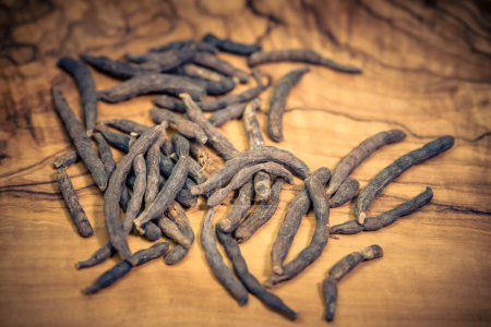 Photo for Black long pepper xylopia aethiopica on olive wood - Royalty Free Image