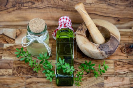 green Woodruff vinegar on olive wood
