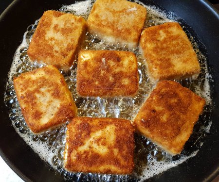 breaded and baked greek sheep's cheese with herbs and spices
