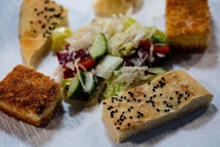 breaded and baked greek sheep's cheese with herbs and spices