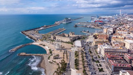 Photo for Panoramic view of the city of Civitavecchia with the adjoining tourist port and Forte Michelangelo. Emerald sea and view with tropical palm trees. Ferris wheel and cloudy sky. - Royalty Free Image