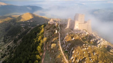 Rocca Calascio at sunset with warm light and clouds