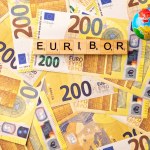 Word EURIBOR Is Written In Wooden Letters On Background Of 200 Euro Banknotes And Globe. Copy paste. High quality photo