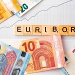 Word EURIBOR Is Written In Wooden Letters On Background Of Euro Banknotes. Copy paste. High quality photo