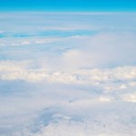 View from Boeing 737 MAX 8 on White Air Clouds, Clear Blue Sky. High quality photo