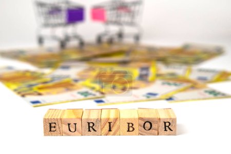 Photo for Word EURIBOR Is Written In Wooden Letters On Background Banknotes and Shopping Baskets. Copy paste. High quality photo - Royalty Free Image