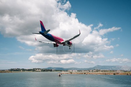 Photo for Kerkyra, Greece - 09 24 2022: Wizz air Airplane Is Landing At Corfu Airport. The Concept Of Travel To Separated Places And Islands. Air Service Between The Mainland And The Island. High quality photo - Royalty Free Image