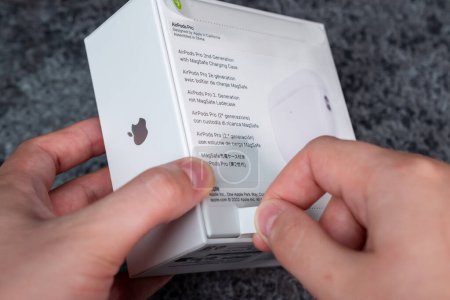 Photo for Jurmala, Latvia - 21 09 2023: Unboxing new Apple gadget. Woman tears off a protective strip in a box with new headphones - AirPods Pro 2 generation. High quality photo - Royalty Free Image