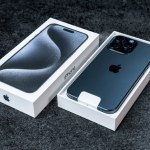 Jurmala, Latvia - 30 11 2023: Box and new smarphone apple iPhone 15 Pro Max in Blue Titanium color on grey table. High quality photo
