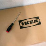 Jurmala, Latvia - 18 02 2024: A box of Ikea furniture and a screwdriver to assemble the furniture. . High quality photo