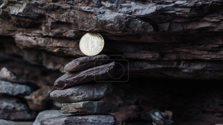Bitcoin coin against a dark stone wall background. The concept of electronic currency stability. High quality photo