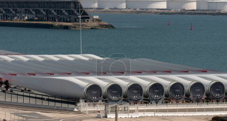 Photo for Port of Le Havre northern France. June 2023. Offshore wind turbine urbine blades  on the quayside bound for St Brieuc wind farm, off Brittany, France. - Royalty Free Image