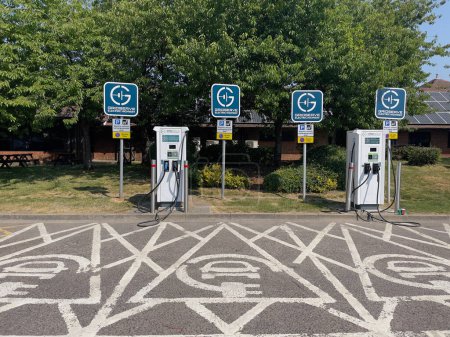 Photo for Westerham, Kent, England, UK. 2023. Electric vehicle points in a service station parking area. - Royalty Free Image