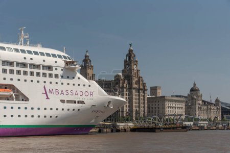 Photo for Liverpool, England, UK. June 2023.  A cruise ship berthed on the Liverpool waterfront in view of the famous Liver Building - Royalty Free Image