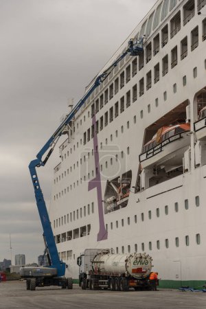 Photo for Belfast, Northern Ireland.  7 June 2023.  Cruise ship alongside in Belfast cruise ship berth . Extended crane cleaning windows and paintwork - Royalty Free Image