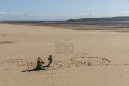 Photo for Weston Super Mare, Somerset, England, UK. 25 June 2023. Young couple enjoying the large beach at Weston Super Mare, Somerset, England, UK. - Royalty Free Image
