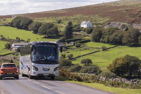 Photo for Dartmoor national park, Devon, England, UK. 4th September 2023. German tour bus travelling in Dartmoor national park, Devon, England, UK. - Royalty Free Image