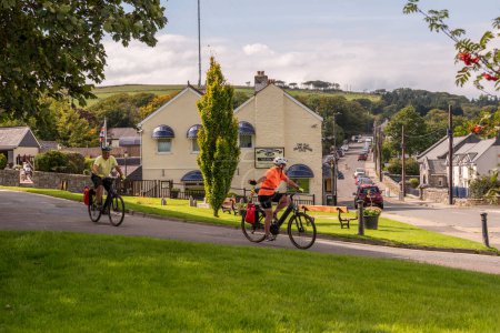 Photo for Princetown, Dartmoor, Devon, England, UK. 6 September 2023.  Cyclists passing through Princetown high on Dartmoor, Devon, UK. - Royalty Free Image