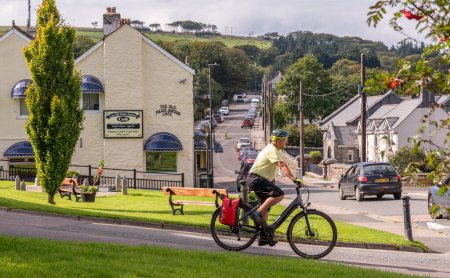 Photo for Princetown, Dartmoor, Devon, England, UK. 6 September 2023.  Cyclist passing through Princetown high on Dartmoor, Devon, UK. - Royalty Free Image