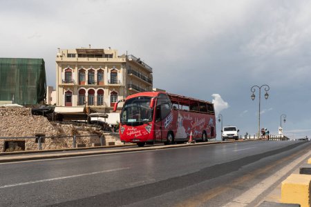 Photo for Herkalion, Crete, Greece, Europe. 26.09.2023. Tourist sightseeing bus on a city dual carriageway highway. - Royalty Free Image