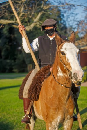 Foto de BUENOS AIRES, ARGENTINA - 13 de abril de 2022: Hombre a caballo con bandera - Imagen libre de derechos