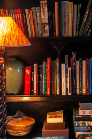 Photo for Closeup of books and lamp in the room - Royalty Free Image