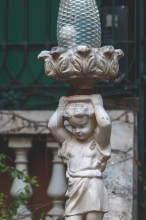 Photo for Statue of a boy carrying a vase on his head - Royalty Free Image