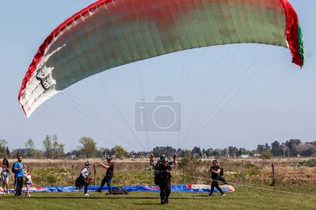 Photo for A group of people standing around a parachute - Royalty Free Image