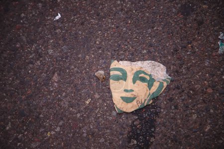 Photo for Face on a piece of cardboard on the ground - Royalty Free Image