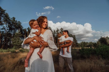 Téléchargez les photos : Une balade en famille en pleine nature avec deux enfants, sœurs jumelles; - en image libre de droit